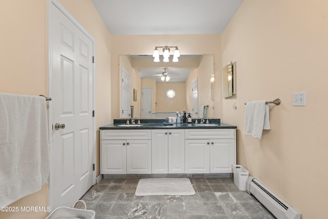 367 Kirby Ave, Long Branch, NJ 07740 - bathroom featuring a baseboard radiator, double vanity, stone finish floors, and a ceiling fan
