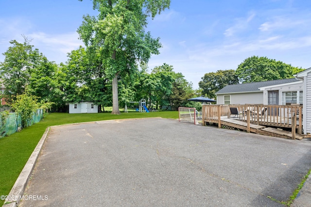 367 Kirby Ave, Long Branch, NJ 07740 - view of yard featuring a playground, a deck, and a storage unit