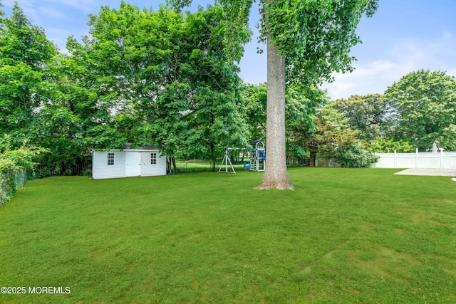 367 Kirby Ave, Long Branch, NJ 07740 - fenced backyard with a playground, a shed, and view of wooded area