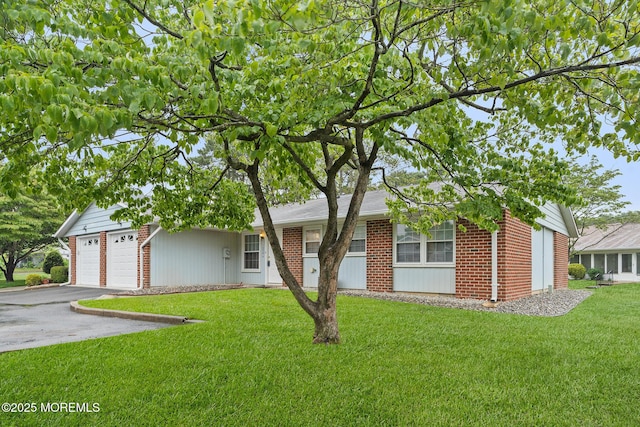 1058A Argyll Cir, Lakewood, NJ 08701 - view of front facade featuring brick siding, a front lawn, and driveway