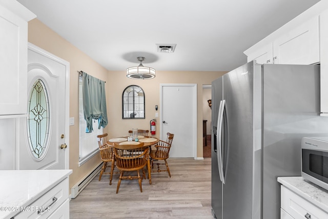 1058A Argyll Cir, Lakewood, NJ 08701 - dining room featuring a baseboard radiator and light wood-type flooring