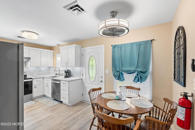 1058A Argyll Cir, Lakewood, NJ 08701 - kitchen featuring stainless steel appliances, a ceiling fan, decorative backsplash, light countertops, and white cabinets