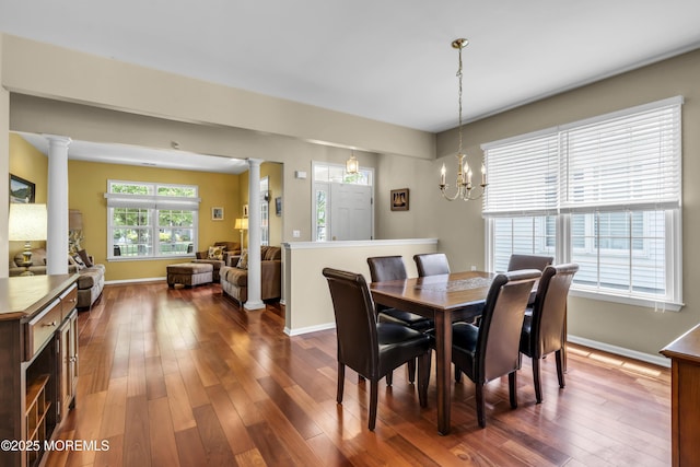 110 Rolling Meadows Blvd S, Ocean Twp, NJ 07712 - dining space with decorative columns, dark wood-style flooring, and a chandelier