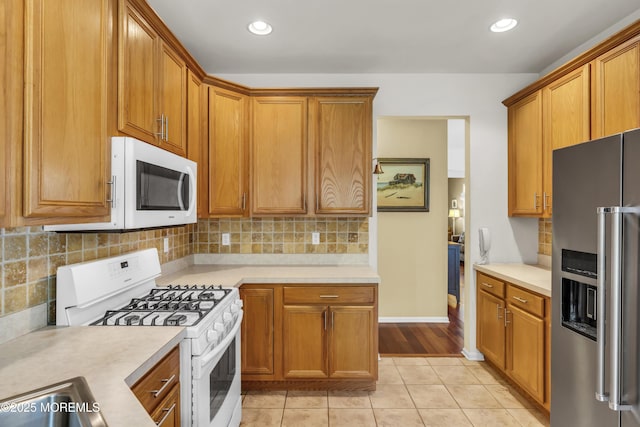 110 Rolling Meadows Blvd S, Ocean Twp, NJ 07712 - kitchen with white appliances, light countertops, light tile patterned floors, brown cabinets, and recessed lighting