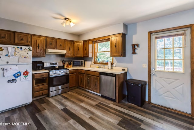 214 Conifer Dr, Forked River, NJ 08731 - kitchen with stainless steel appliances, light countertops, under cabinet range hood, dark wood-type flooring, and brown cabinetry