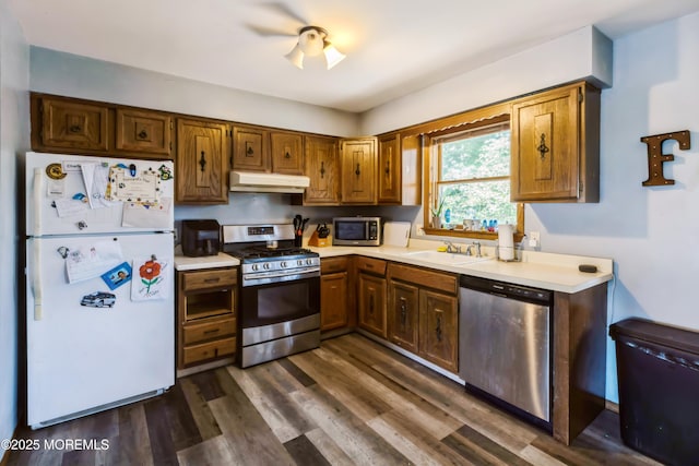 214 Conifer Dr, Forked River, NJ 08731 - kitchen with appliances with stainless steel finishes, under cabinet range hood, light countertops, and dark wood-style floors
