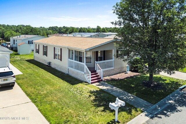 1104 Sycamore Ct, Whiting, NJ 08759 - view of front of home with a porch, a shingled roof, and a front lawn