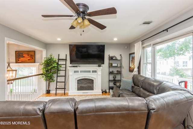 27 Gillette St, Keansburg, NJ 07734 - living area with ceiling fan, a fireplace with raised hearth, recessed lighting, and wood finished floors