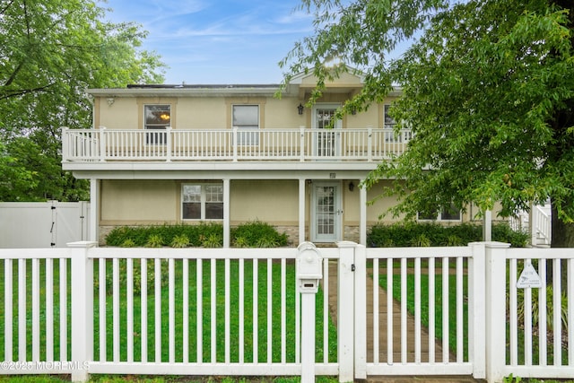 27 Gillette St, Keansburg, NJ 07734 - view of front of house featuring a gate, stucco siding, a balcony, and a fenced front yard