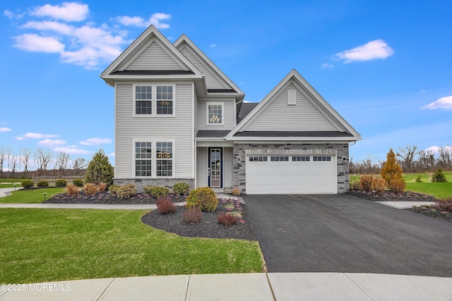 12 Prado Rd, Monroe, NJ 08831 - view of front of house featuring stone siding, driveway, an attached garage, and a front lawn
