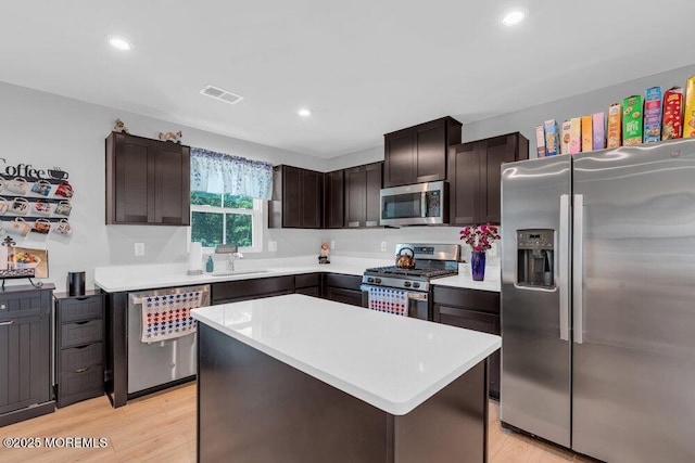 703 Cyprus Ct, Forked River, NJ 08731 - kitchen featuring appliances with stainless steel finishes, dark brown cabinets, light countertops, light wood-type flooring, and recessed lighting