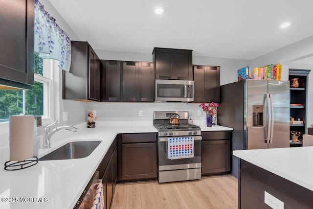 703 Cyprus Ct, Forked River, NJ 08731 - kitchen featuring appliances with stainless steel finishes, light countertops, light wood-style floors, dark brown cabinets, and recessed lighting