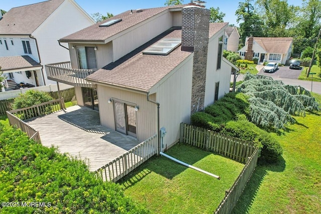 1120 Pennsylvania Ave, Manasquan, NJ 08736 - back of property featuring a chimney, a shingled roof, a fenced backyard, and a wooden deck