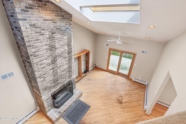 1120 Pennsylvania Ave, Manasquan, NJ 08736 - unfurnished living room with a skylight, baseboard heating, lofted ceiling, light wood-style flooring, and recessed lighting