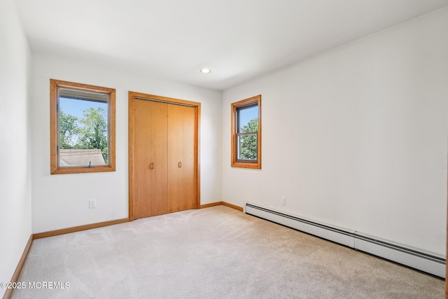 1120 Pennsylvania Ave, Manasquan, NJ 08736 - unfurnished bedroom featuring baseboard heating, multiple windows, carpet flooring, a closet, and recessed lighting