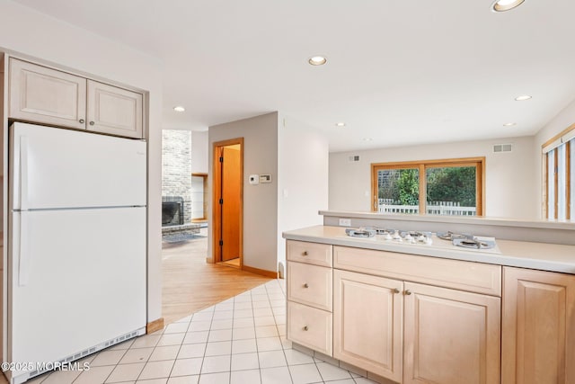 1120 Pennsylvania Ave, Manasquan, NJ 08736 - kitchen with white appliances, recessed lighting, light countertops, a brick fireplace, and light brown cabinetry