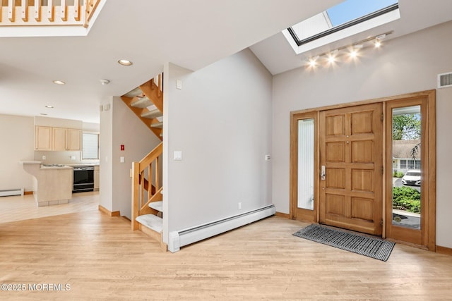 1120 Pennsylvania Ave, Manasquan, NJ 08736 - foyer featuring baseboard heating, stairs, a skylight, light wood finished floors, and recessed lighting