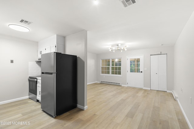 1034 Aberdeen Dr Unit E, Lakewood, NJ 08701 - kitchen with stainless steel appliances, a baseboard heating unit, a chandelier, white cabinetry, and light wood-style floors