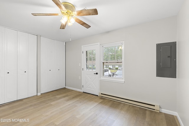 1034 Aberdeen Dr Unit E, Lakewood, NJ 08701 - unfurnished bedroom with electric panel, a baseboard radiator, two closets, and light wood finished floors