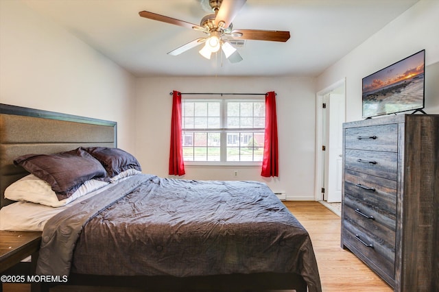 111 Edinburgh Ln Unit D, Lakewood, NJ 08701 - bedroom featuring light wood-style flooring, a baseboard heating unit, and a ceiling fan
