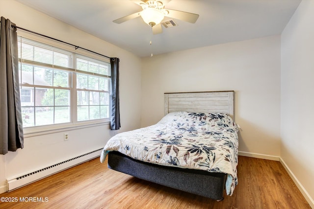 111 Edinburgh Ln Unit D, Lakewood, NJ 08701 - bedroom with a baseboard heating unit, wood finished floors, and ceiling fan
