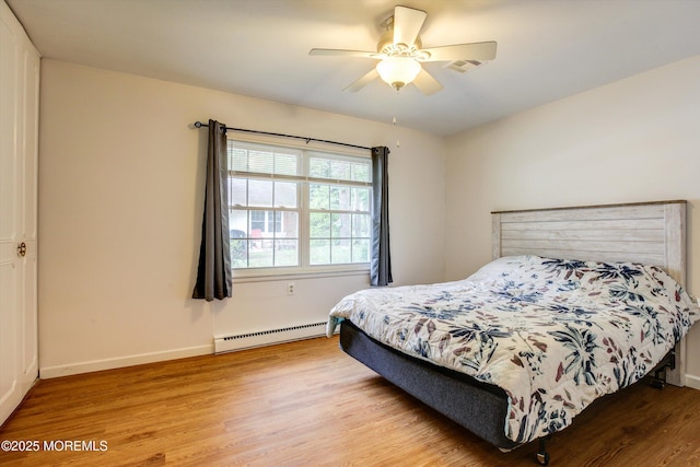 111 Edinburgh Ln Unit D, Lakewood, NJ 08701 - bedroom featuring baseboard heating, light wood-style flooring, and a ceiling fan