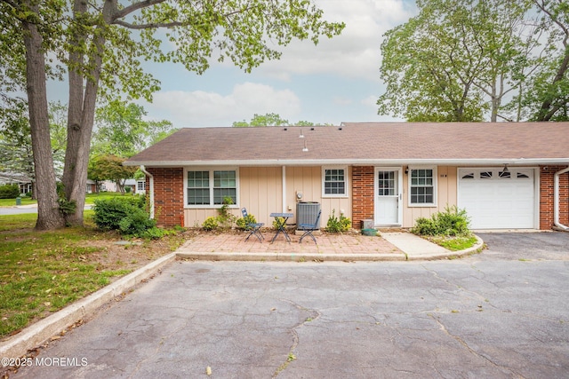 111 Edinburgh Ln Unit D, Lakewood, NJ 08701 - ranch-style house with board and batten siding, an attached garage, and brick siding