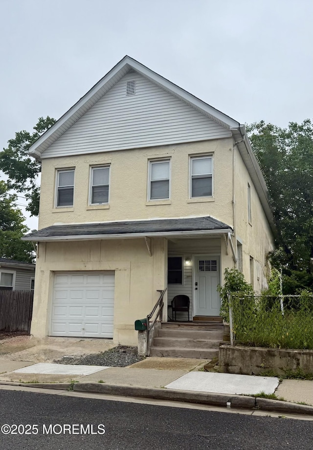 77 Center Ave, Keansburg, NJ 07734 - view of front of property with a garage and stucco siding