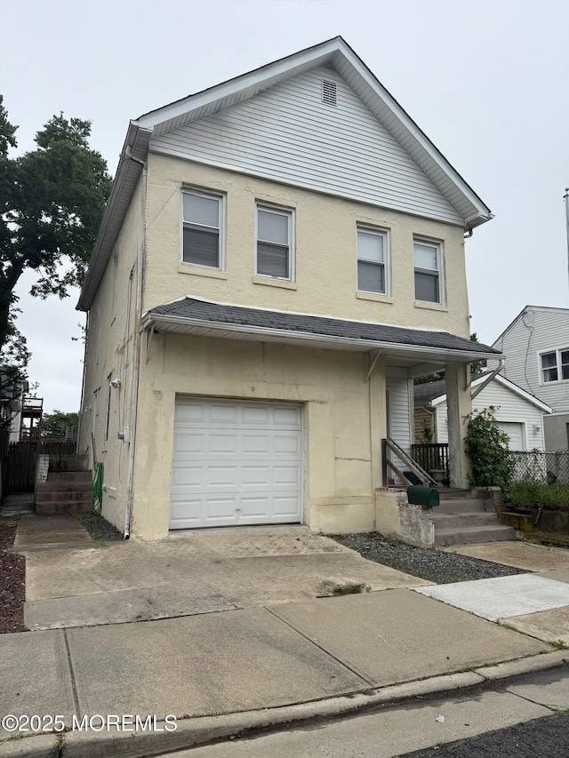 77 Center Ave, Keansburg, NJ 07734 - multi unit property with an attached garage, driveway, stucco siding, and covered porch