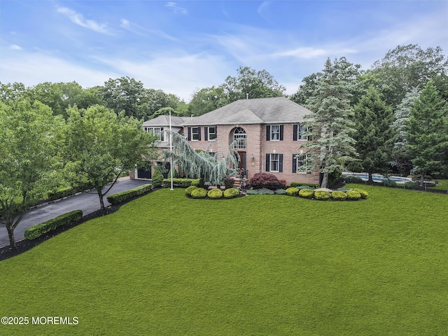 1020 Aumack Rd, Jackson, NJ 08527 - view of front of property with stairs, asphalt driveway, a front lawn, brick siding, and an outdoor pool