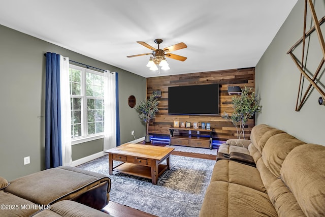 1020 Aumack Rd, Jackson, NJ 08527 - living room featuring wooden walls, a ceiling fan, an accent wall, and wood finished floors