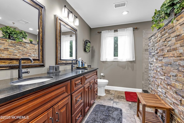 1020 Aumack Rd, Jackson, NJ 08527 - full bathroom with double vanity, stone tile floors, recessed lighting, and tiled shower