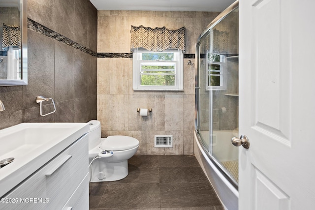 117 Greymoor Rd, Howell, NJ 07731 - bathroom featuring tile walls, vanity, and bath / shower combo with glass door