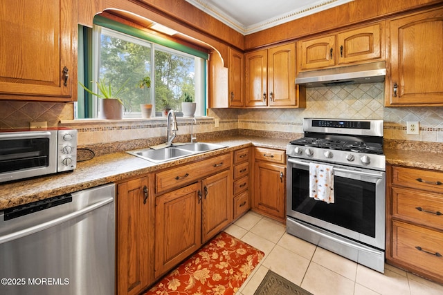 117 Greymoor Rd, Howell, NJ 07731 - kitchen with stainless steel appliances, under cabinet range hood, brown cabinets, and ornamental molding