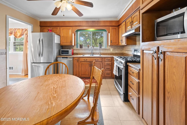 117 Greymoor Rd, Howell, NJ 07731 - kitchen featuring stainless steel appliances, under cabinet range hood, light tile patterned flooring, brown cabinets, and ceiling fan