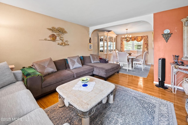117 Greymoor Rd, Howell, NJ 07731 - living area with arched walkways, a chandelier, and light wood finished floors