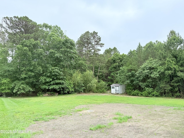 6 Eagle Ridge Ln, West Creek, NJ 08092 - view of grassy yard with a storage shed and a wooded view
