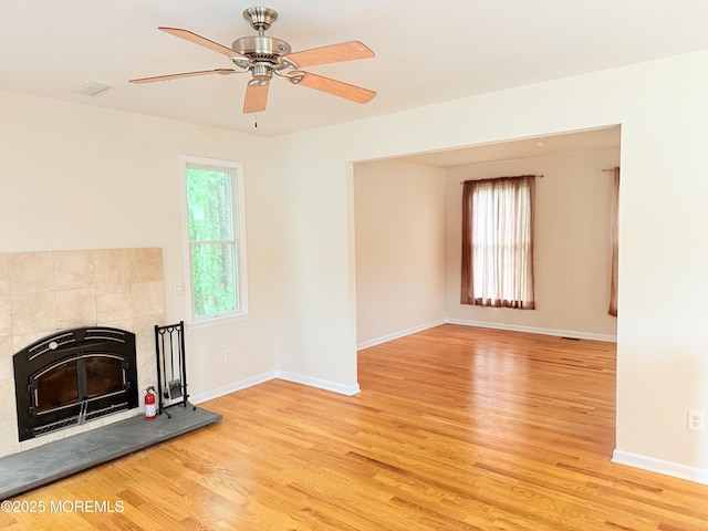 6 Eagle Ridge Ln, West Creek, NJ 08092 - unfurnished living room with light wood-style flooring, a ceiling fan, heating unit, and a fireplace