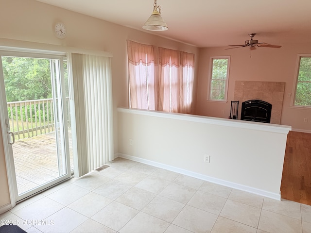 6 Eagle Ridge Ln, West Creek, NJ 08092 - unfurnished dining area featuring plenty of natural light, a ceiling fan, and a tiled fireplace