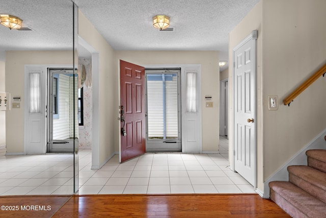 11 Old Orchard Ln, Ocean Twp, NJ 07712 - entrance foyer featuring stairs, a textured ceiling, and light tile patterned floors