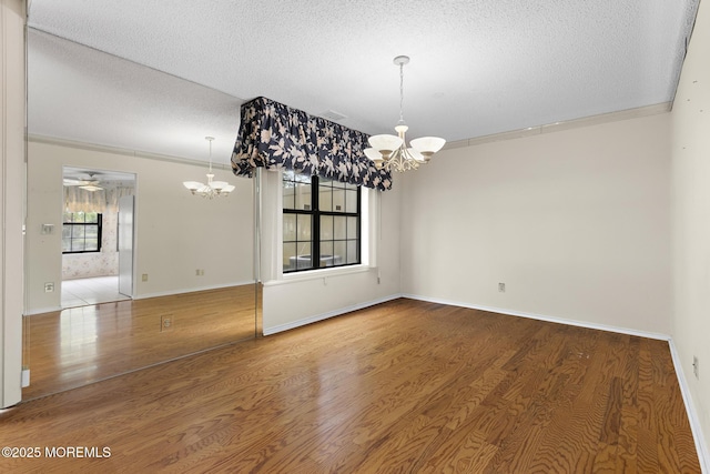 11 Old Orchard Ln, Ocean Twp, NJ 07712 - unfurnished room featuring a chandelier, a textured ceiling, and wood finished floors