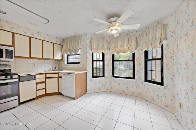 11 Old Orchard Ln, Ocean Twp, NJ 07712 - kitchen with appliances with stainless steel finishes, wallpapered walls, light countertops, a textured ceiling, and ceiling fan
