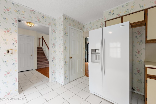 11 Old Orchard Ln, Ocean Twp, NJ 07712 - kitchen featuring white fridge with ice dispenser, wallpapered walls, a textured ceiling, and light tile patterned floors