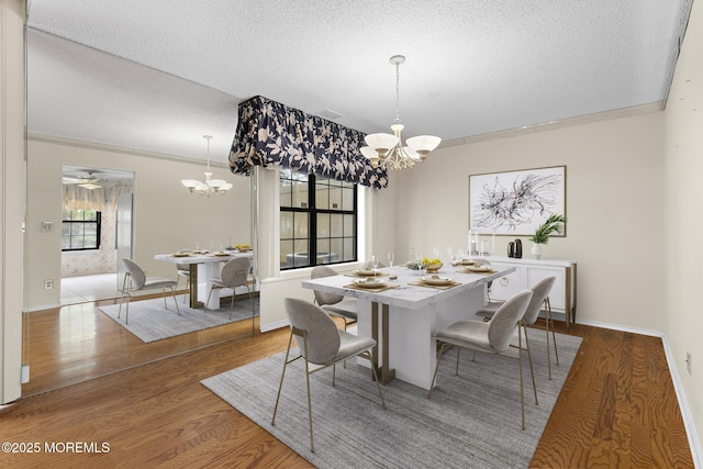 11 Old Orchard Ln, Ocean Twp, NJ 07712 - dining room featuring a chandelier, a textured ceiling, and wood finished floors
