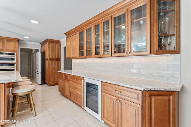 20 Birch Ln, Colts Neck, NJ 07722 - kitchen with wine cooler, high quality fridge, double oven, crown molding, and brown cabinets