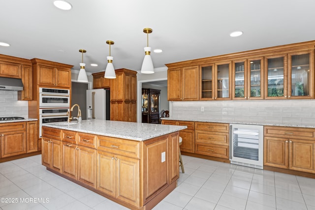20 Birch Ln, Colts Neck, NJ 07722 - kitchen featuring wine cooler, stainless steel gas cooktop, decorative backsplash, white fridge with ice dispenser, and under cabinet range hood