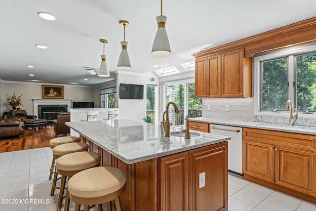 20 Birch Ln, Colts Neck, NJ 07722 - kitchen with dishwasher, light tile patterned floors, open floor plan, brown cabinetry, and a kitchen breakfast bar