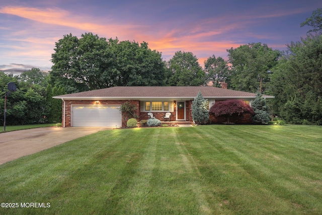 3 Mcelwaine Dr, Freehold, NJ 07728 - view of front of home featuring concrete driveway, a chimney, a garage, a yard, and brick siding
