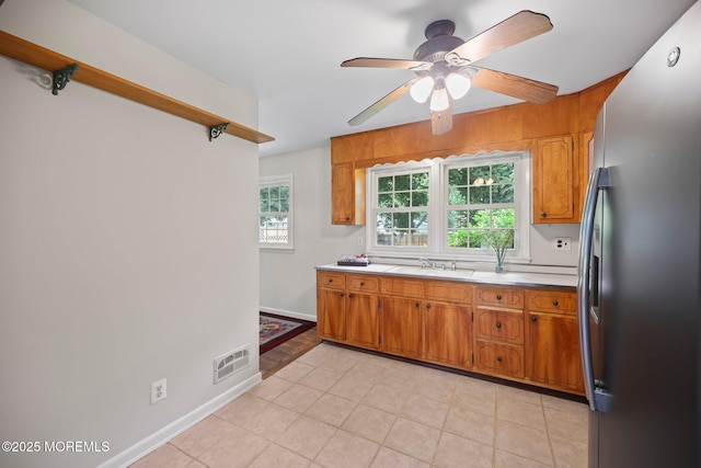 3 Mcelwaine Dr, Freehold, NJ 07728 - kitchen featuring freestanding refrigerator, a ceiling fan, light countertops, brown cabinets, and light tile patterned flooring