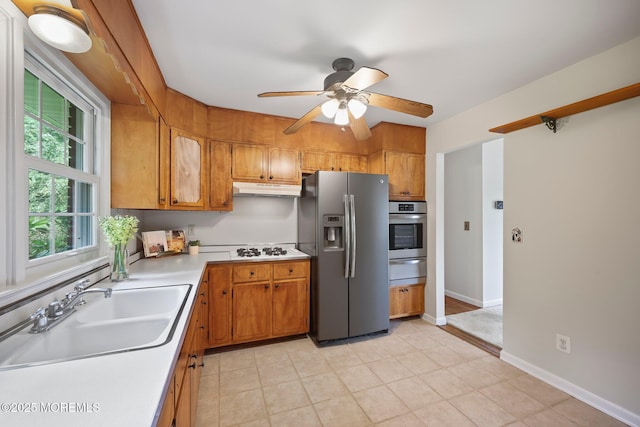 3 Mcelwaine Dr, Freehold, NJ 07728 - kitchen with stainless steel appliances, under cabinet range hood, light countertops, ceiling fan, and brown cabinets